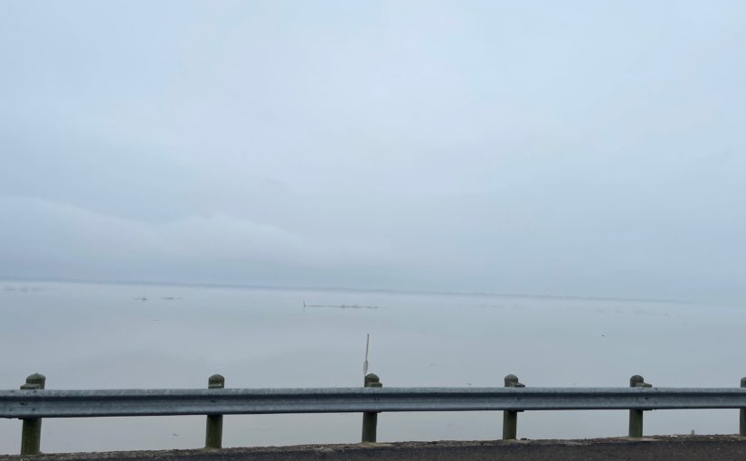 Bridge over lake in very foggy weather