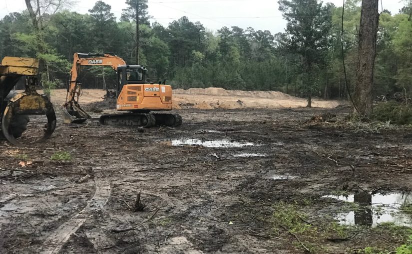 Construction equipment clearing land